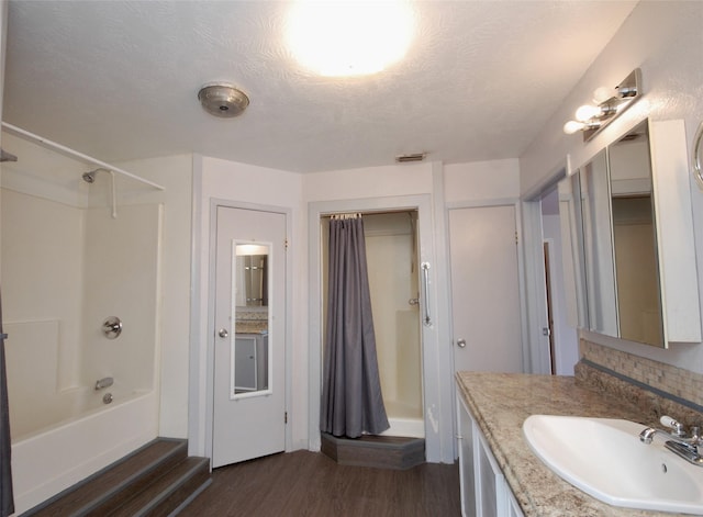 bathroom with vanity, shower / bathtub combination, and wood finished floors