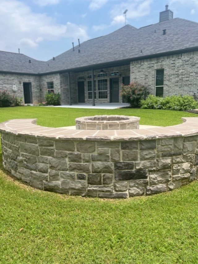 rear view of property featuring a patio area and a yard