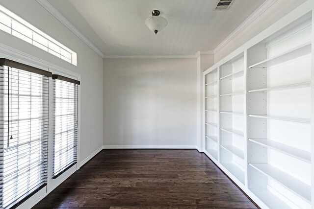 empty room with ornamental molding, dark hardwood / wood-style floors, and plenty of natural light