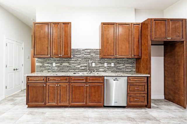 kitchen featuring light stone counters, sink, dishwasher, and light tile floors