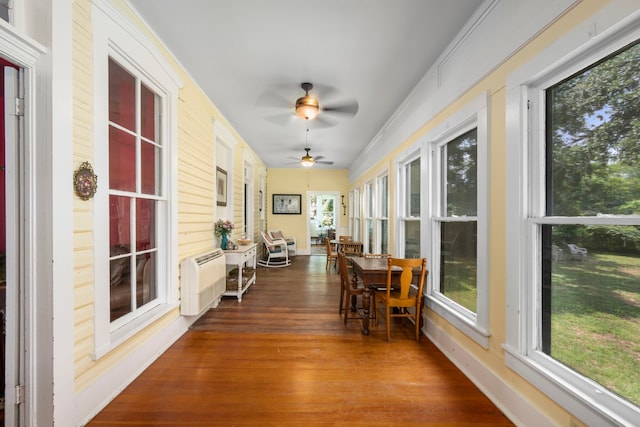 sunroom / solarium featuring radiator heating unit and ceiling fan