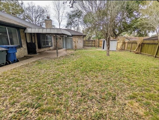 view of yard featuring a patio area and a storage unit