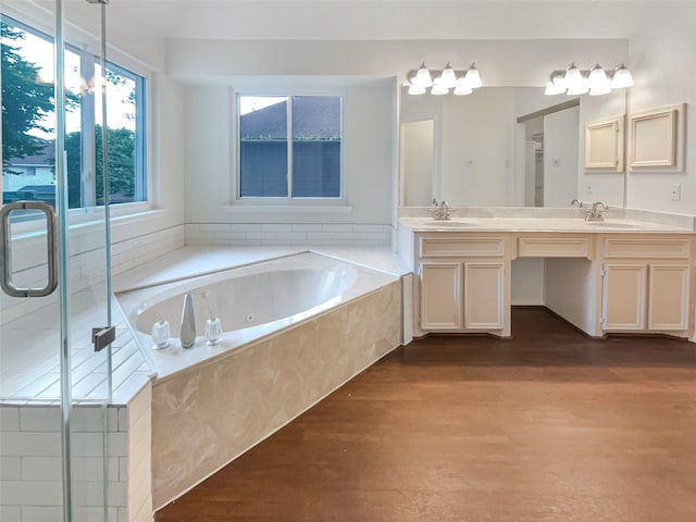 bathroom with hardwood / wood-style floors, vanity, and separate shower and tub