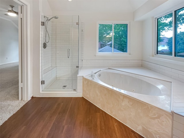 bathroom with hardwood / wood-style flooring, shower with separate bathtub, and a wealth of natural light