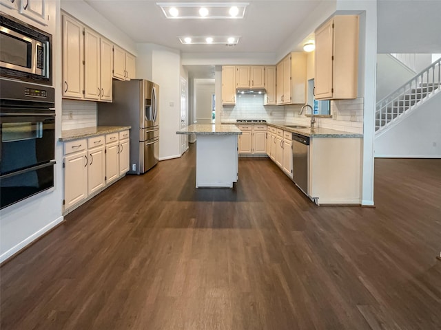 kitchen featuring light stone countertops, appliances with stainless steel finishes, and a kitchen island