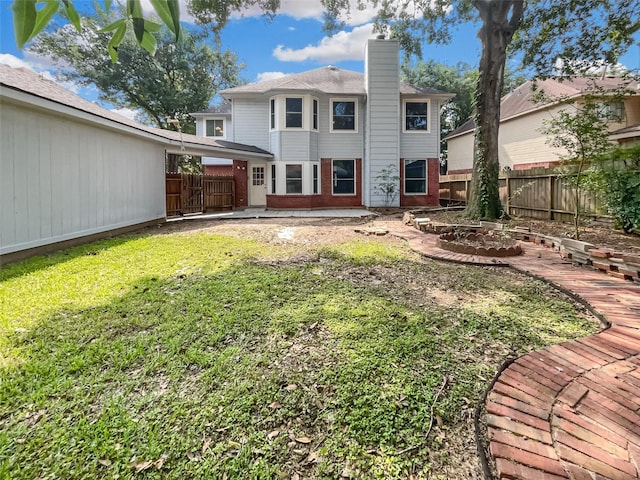 rear view of property with a yard