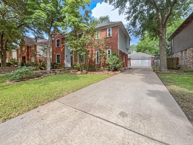 view of front of home featuring a garage, a front lawn, and an outdoor structure