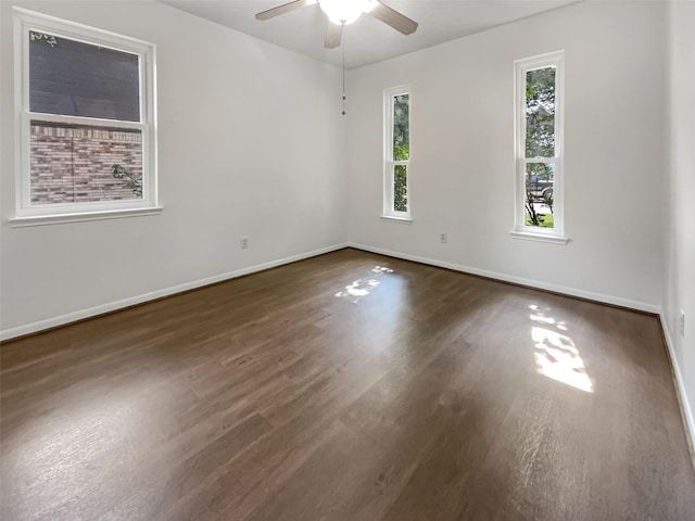 spare room with dark hardwood / wood-style flooring and ceiling fan