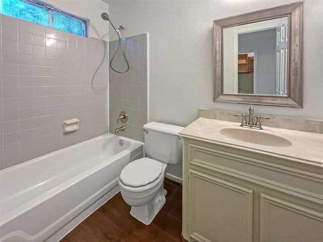 full bathroom with vanity, toilet, tiled shower / bath, and hardwood / wood-style flooring