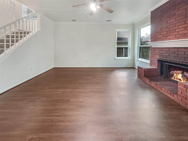 unfurnished living room with a fireplace, dark hardwood / wood-style floors, ceiling fan, and ornamental molding