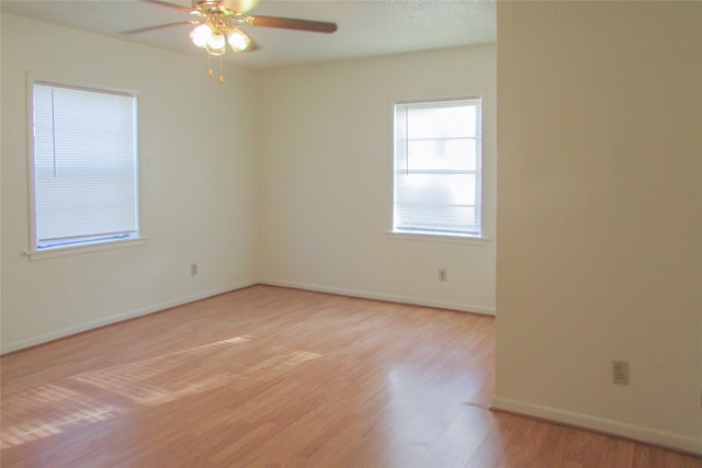 spare room with ceiling fan and hardwood / wood-style flooring