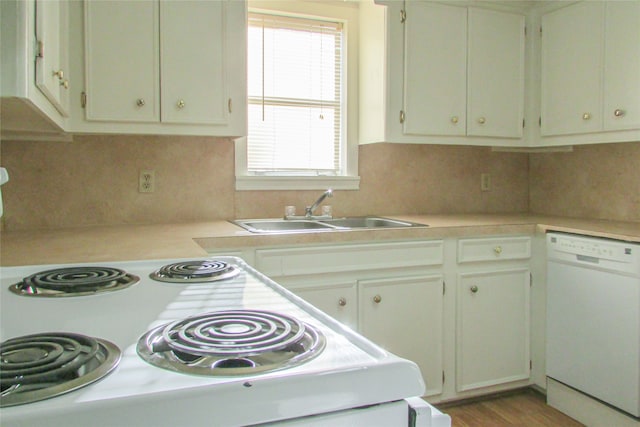 kitchen featuring sink, white cabinetry, tasteful backsplash, and white dishwasher