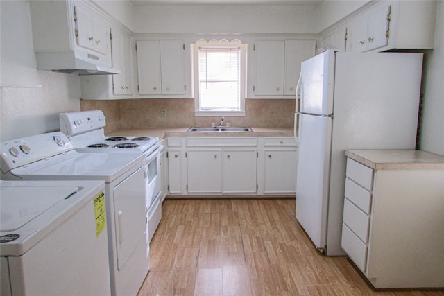 laundry area with sink and light hardwood / wood-style flooring