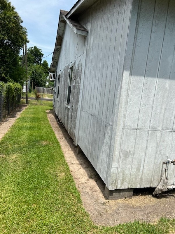 view of side of home with a lawn