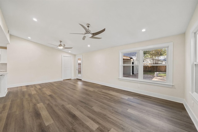 unfurnished living room featuring vaulted ceiling, dark wood-type flooring, and ceiling fan