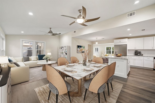 dining area with wood-type flooring, lofted ceiling, and ceiling fan