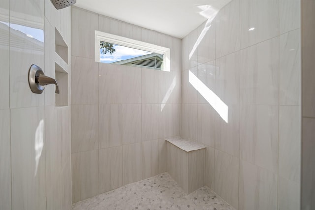 bathroom with a tile shower