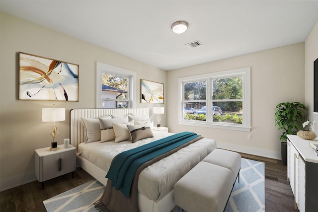 bedroom with dark hardwood / wood-style flooring