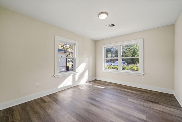 unfurnished room featuring dark hardwood / wood-style flooring