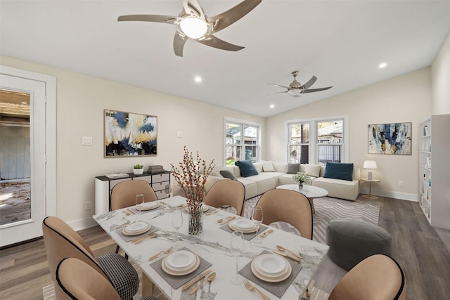 dining area featuring vaulted ceiling, hardwood / wood-style floors, and ceiling fan