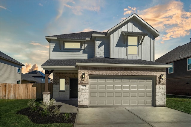 view of front of home with a lawn and a garage