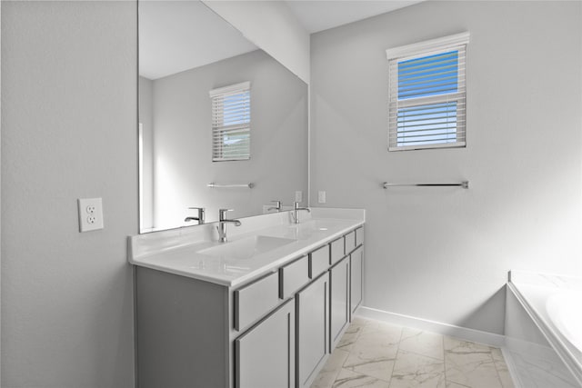 bathroom featuring a washtub and vanity