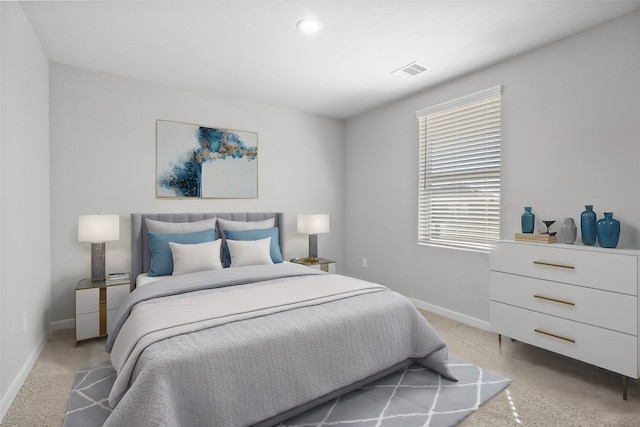 bedroom featuring light carpet