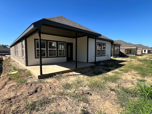 back of property with a patio area