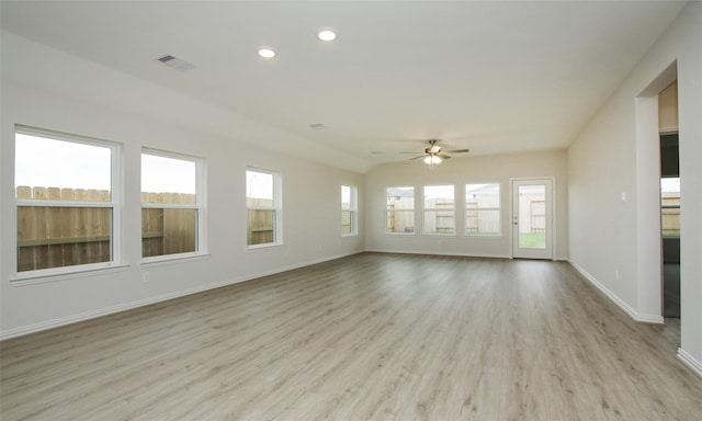 unfurnished sunroom with ceiling fan and vaulted ceiling