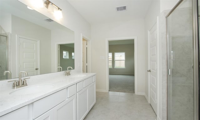 bathroom with tile patterned floors, vanity, and walk in shower