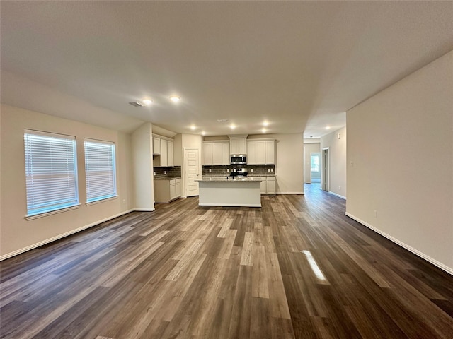 unfurnished living room featuring dark hardwood / wood-style floors