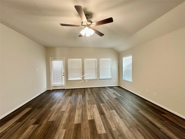 unfurnished living room featuring ceiling fan, dark hardwood / wood-style floors, and vaulted ceiling