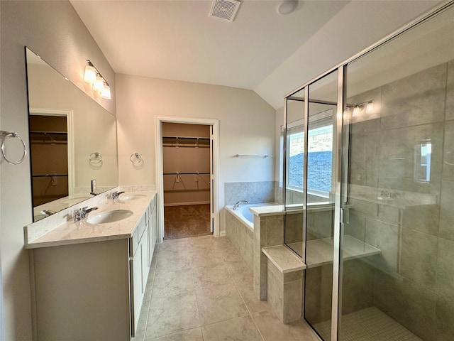 bathroom featuring a water view, vanity, tile patterned flooring, and plus walk in shower