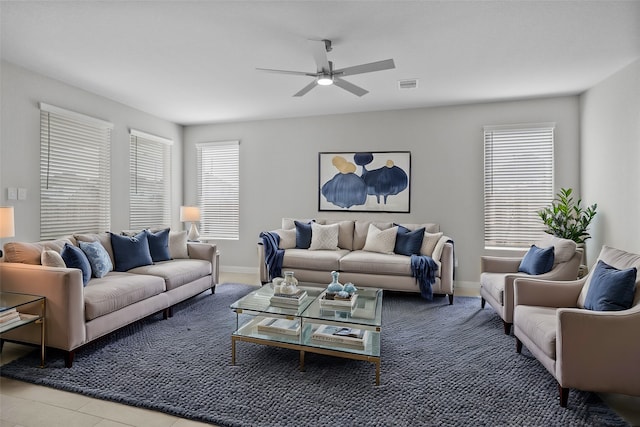 tiled living room with ceiling fan