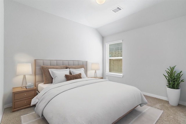 bedroom featuring light colored carpet and lofted ceiling