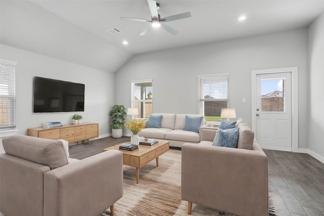 living room with wood-type flooring, vaulted ceiling, and ceiling fan