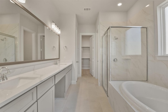 bathroom featuring tile patterned flooring, vanity, and separate shower and tub