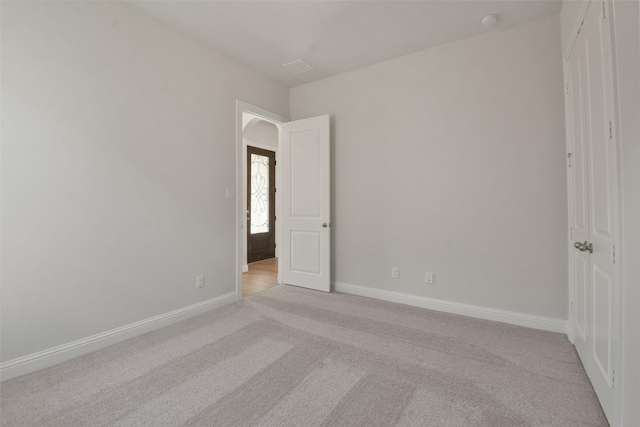 unfurnished room with light colored carpet