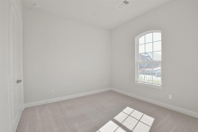 spare room featuring light colored carpet