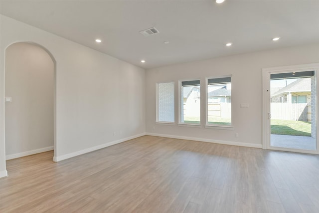 spare room featuring light hardwood / wood-style floors and a wealth of natural light