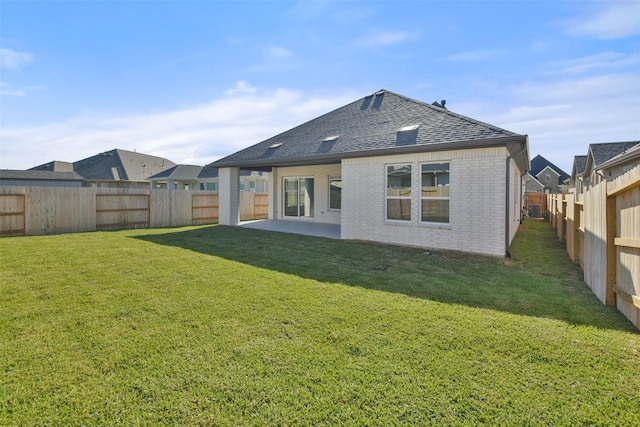 rear view of property with a patio area and a yard