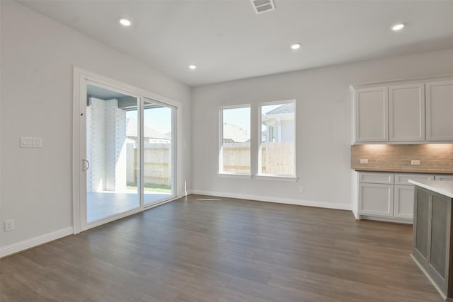 unfurnished living room with dark hardwood / wood-style floors