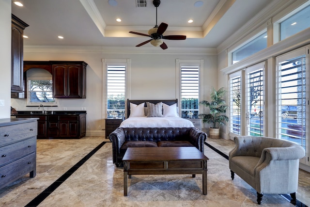 bedroom with a tray ceiling, ceiling fan, and ornamental molding