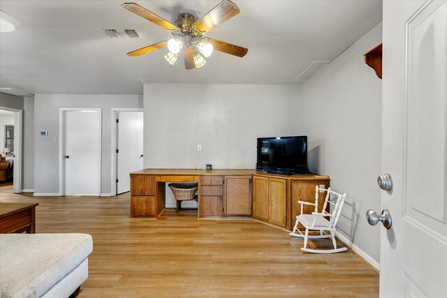 living room featuring ceiling fan and light hardwood / wood-style flooring