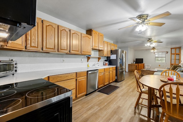 kitchen featuring stainless steel appliances, light hardwood / wood-style flooring, ventilation hood, sink, and ceiling fan