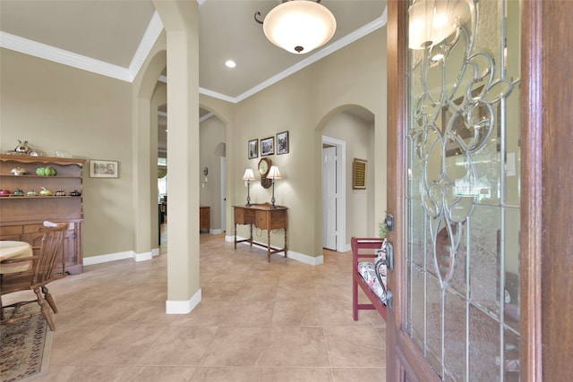 entryway with tile patterned floors and ornamental molding