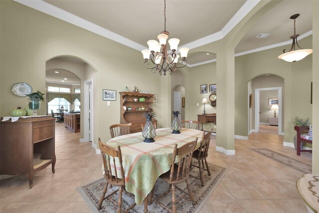 tiled dining space with a chandelier and ornamental molding