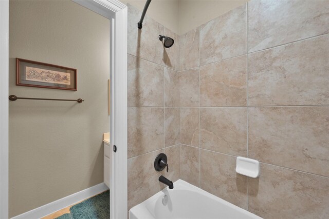 bathroom with vanity and tiled shower / bath combo