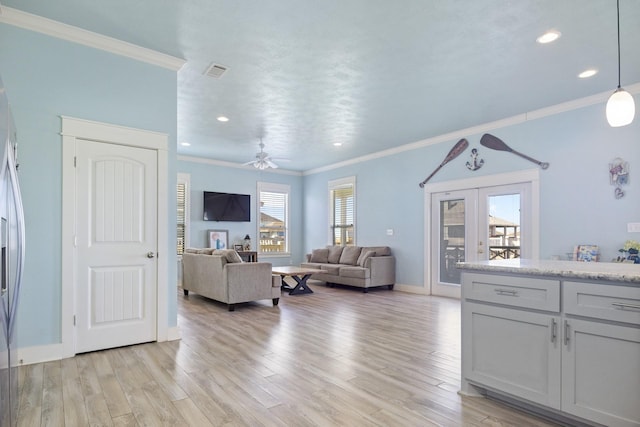 living room with french doors, light hardwood / wood-style floors, ceiling fan, and ornamental molding