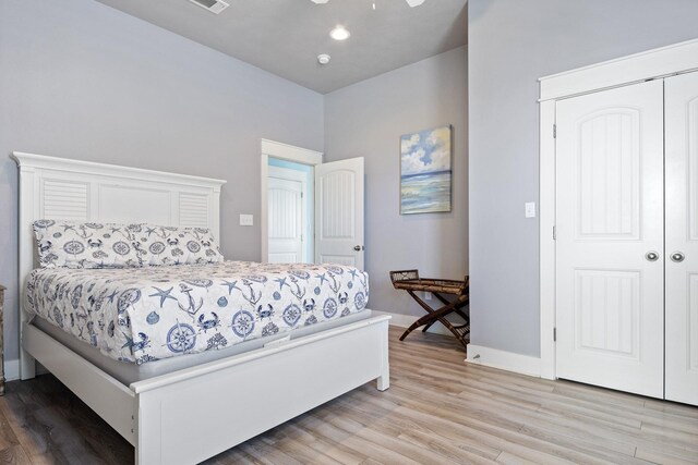 bedroom featuring light hardwood / wood-style flooring and a closet